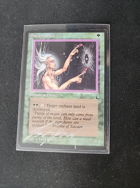 A trading card from a fantasy game displaying an illustration of "Savaen Elves," featuring a mythical elf creature weaving magic in a forest setting. The card includes text descriptions and symbols specific to gameplay. (Magic: The Gathering - Wizards of the Coast)