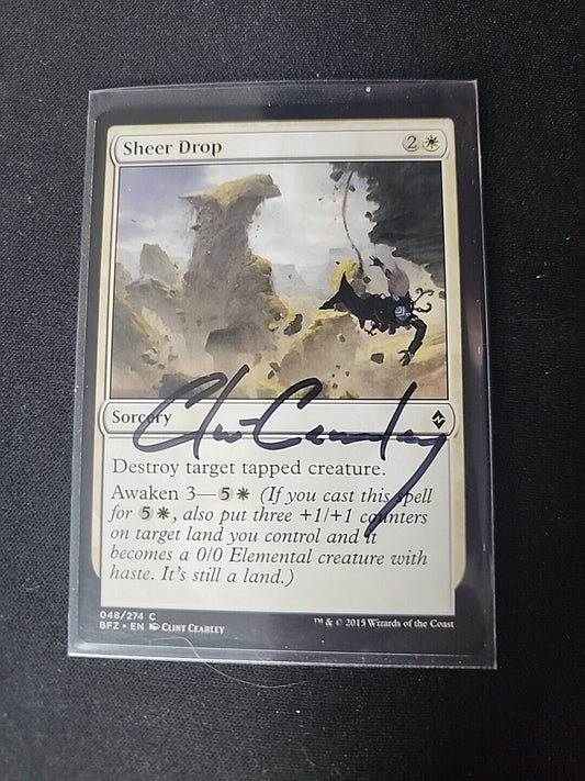 A photo of a "Sheer Drop SIGNED Clint Clearly" Magic: The Gathering card, encased in a protective sleeve, featuring abstract, splashy artwork and an autograph near the center from Wizards of the Coast.