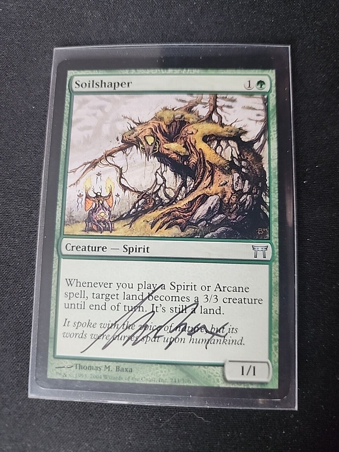 An image of a "Soilshaper SIGNED Thomas M. Baxa Magic the Gathering MTG" trading card featuring an illustration of a magical, tree-like creature in a forest, with game-related text and symbols by Wizards of the Coast.